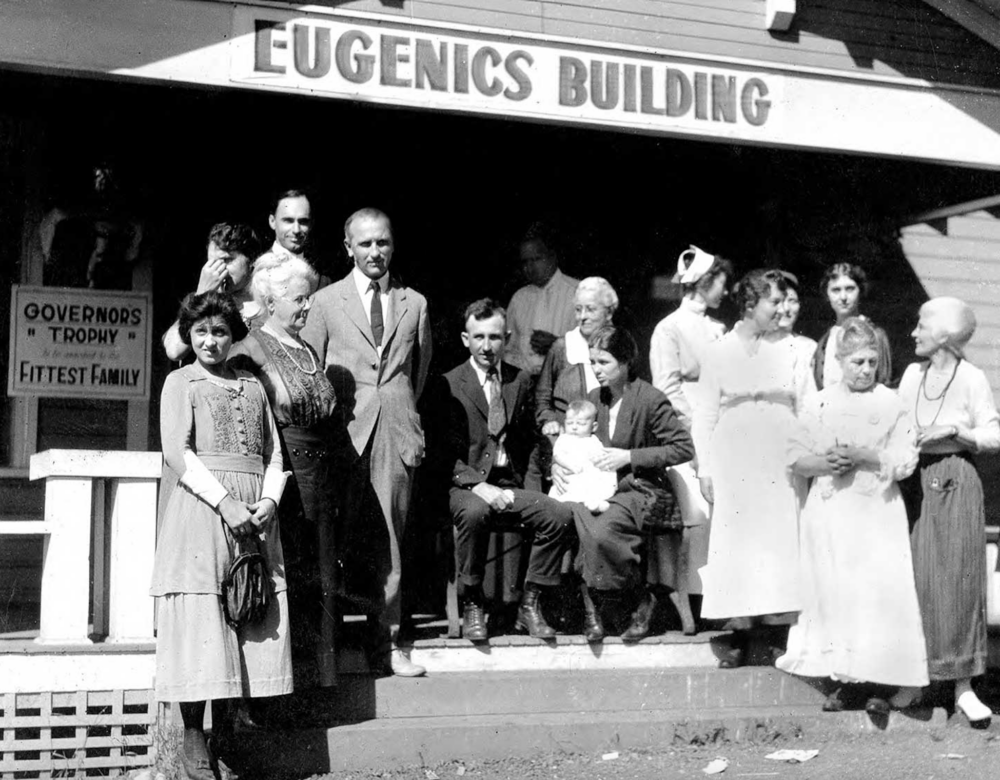 Group of people standing in front of building with "Eugenics Building" on facade